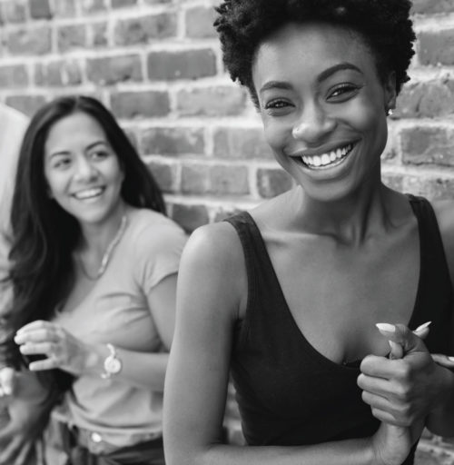 Two women smiling in black and white
