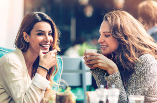 Two Women enjoy beverages on a patio